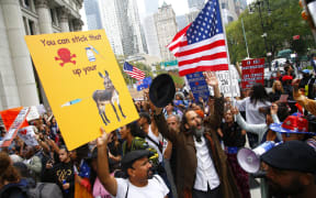 Marchers protest New York's Covid-19  a vaccine mandate for public school employees that came into effect on Monday.