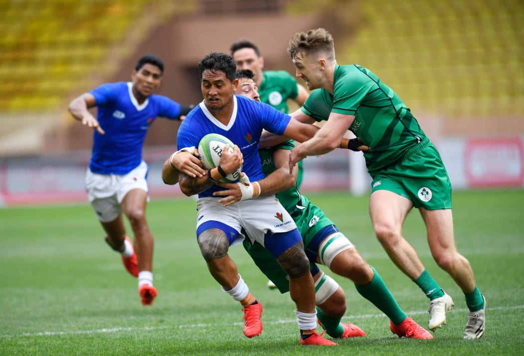Samoa captain Melani Matavao is brought down by the Irish defence.