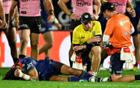 Dallin Watene-Zelezniak of the Warriors lies on the ground injured, NZ Warriors v Penrith Panthers.