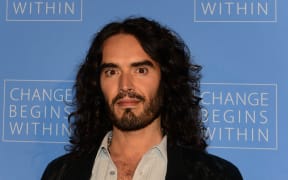 (FILES) Actor Russell Brand poses on arrival with director David Lynch (not pictured) to launch “Meditation in Education”, a Global Outreach campaign to teach 1,000,000 at-risk youth "Meditation in Education" on April 2, 2013 in Los Angeles, California. British comedian and actor Russell Brand has been accused of rape, sexual assaults and emotional abuse during a seven-year period, according to the results of a media investigation published on September 16, 2023. (Photo by Frederic J. BROWN / AFP)