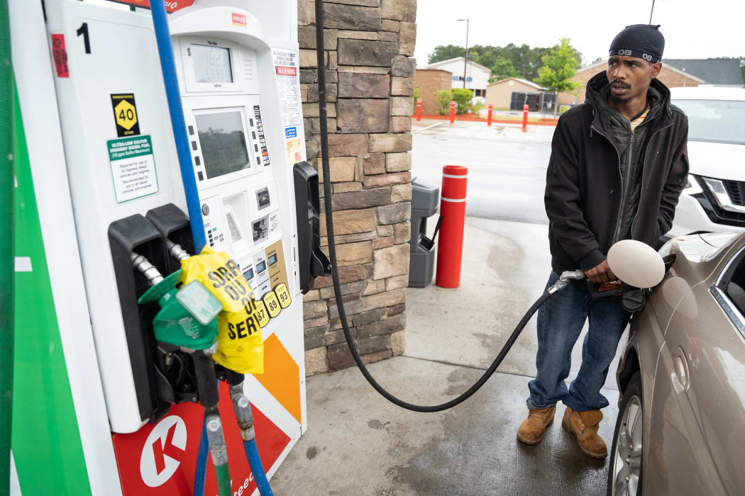 Tavon Clodfelter watches the petrol pump anxiously in Fayetteville, North Carolina, on 12 May. Most stations in the area along  have been without fuel following the hack of the Colonial Pipeline.