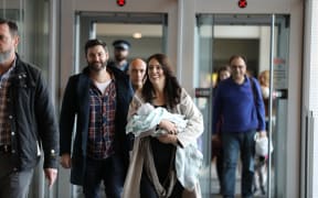 Jacinda Ardern arrives in Wellington with baby Neve and partner Clarke Gayford.
