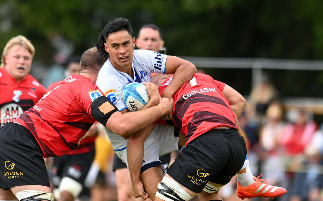 Zarn Sullivan of the Blues is tackled by Tom Christie of the Crusaders.