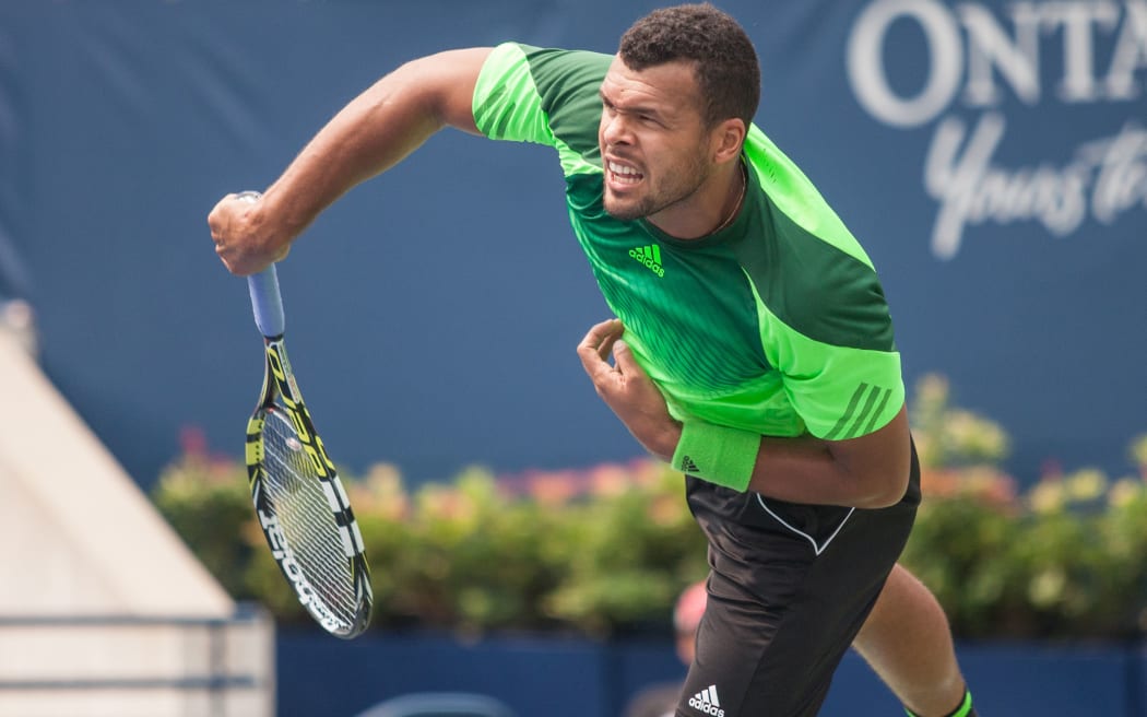 August 7, 2014. Jo-Wilfried Tsonga (FRA) returns the ball during his match against Novak Djokovic (SRB) at the 2014 Rogers Cup being played in Toronto. Tsonga went on to defeat the world No.1 in straight sets 6-2 6-2