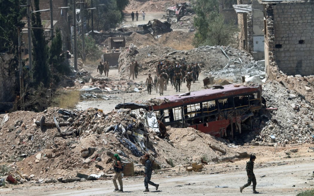 Syrian army soldiers patrol an area near Aleppo.