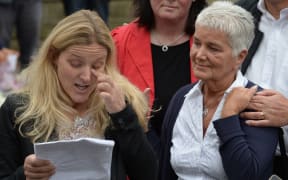 Jean Leadbeater (L), the mother of murdered Labour MP Jo Cox, listens as Kim (L), Jo's sister, reads a tribute in Birstall, northern England.