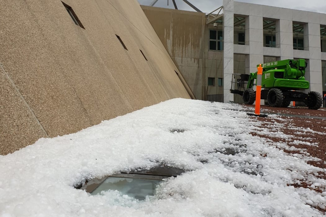 This handout photo taken and received on January 20, 2020 courtesy of Don Arthur shows hail stones outside the Parliament House in Canberra after a storm.