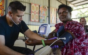 Papua New Guinea (July 7, 2015) Hospitalman Jaime Cavalleroserna, from San Francisco, takes patient vitals during a community health engagement. Medical personnel from the hospital ship USNS Mercy (T-AH 19) arrived in Kokopo  during Pacific Partnership 2015.