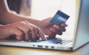 Hands holding credit card and using laptop. Online shopping