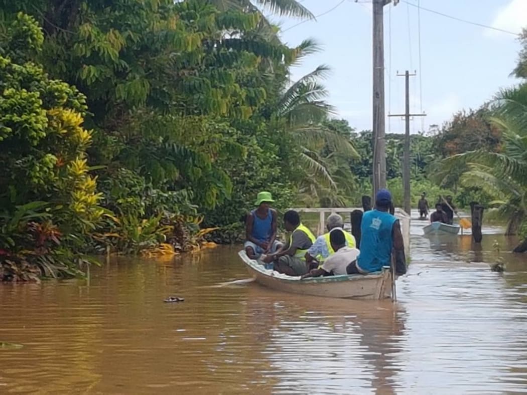 Waivou Village in Rewa Province, Fiji was flooded for a week during floods in December 2016. A Fiji Red Cross team is seen here helping to assess the village's needs.