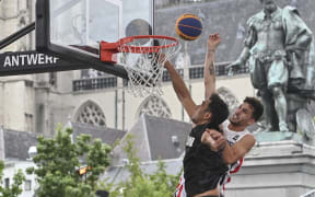 France's Franck Seguela (R) and New Zealand's Tai Wynyard fights for the ball during a 3x3 Basketball game between France and New Zealand, in the Men's qualifying round of the FIBA 2022 World Cup, on June 21, 2022. The tournament of The 2022 FIBA 3x3 World Cup runs between 21 and 26 June 2022 in Antwerp, Belgium. (Photo by DIRK WAEM / BELGA / AFP) / Belgium OUT