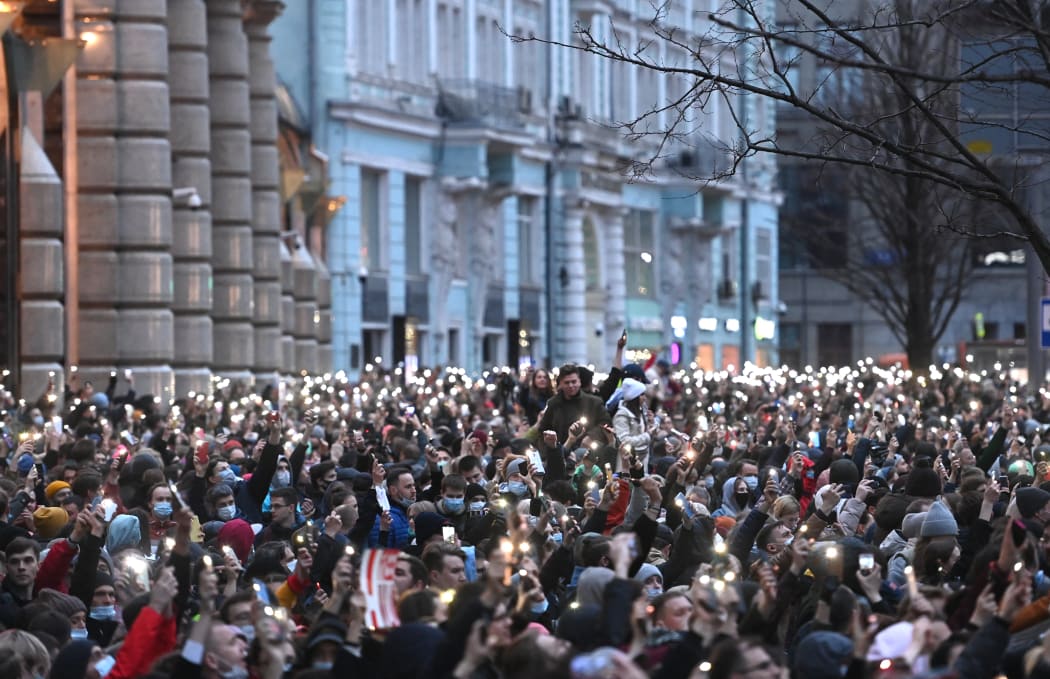Opposition supporters hold their cell phones during a rally in support of jailed Kremlin critic Alexei Navalny, in central Moscow on April 21, 2021.