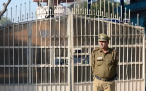 An Indian policeman keeps watch outside Tihar Jail, where four men who were convicted for rape and murder were executed.