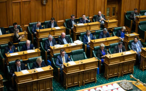 Opposition MPs read through budget documents, take notes, and prepare responses while listening to the Minister of Finance deliver their Budget 2021 statement