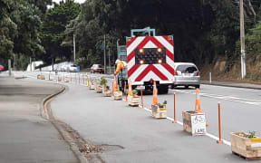 Council contractors remove a DIY protected cycle path in Berhampore, Wellington.