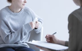 Crying woman suffering from depression and her psychologist