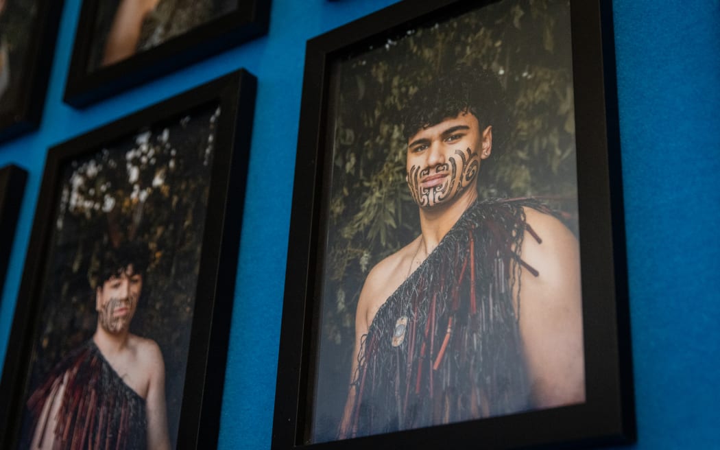 Framed pictures of Te Pā ō Rākaihautū students hang on the walls in the hallways. The students dressed in feather korowai or cloaks, with moko on their faces.
