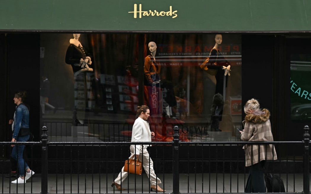 Pedestrians pass a window display for Harrods department store in west London on September 20, 2024. Lawyers on Friday said they were representing 37 women who have accused the late Harrods owner Mohamed Al-Fayed of sexual abuse, and expected "many more" to come forward with civil claims. Multiple ex-Harrods employees accused him of sexual abuse, including five claiming they were raped by Fayed, who died last year aged 94, according to a BBC investigation published yesterday. (Photo by Ben STANSALL / AFP)