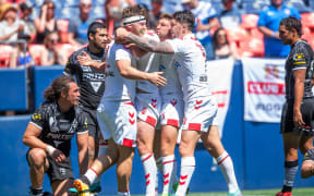England celebrate a try against the Kiwis in Denver.