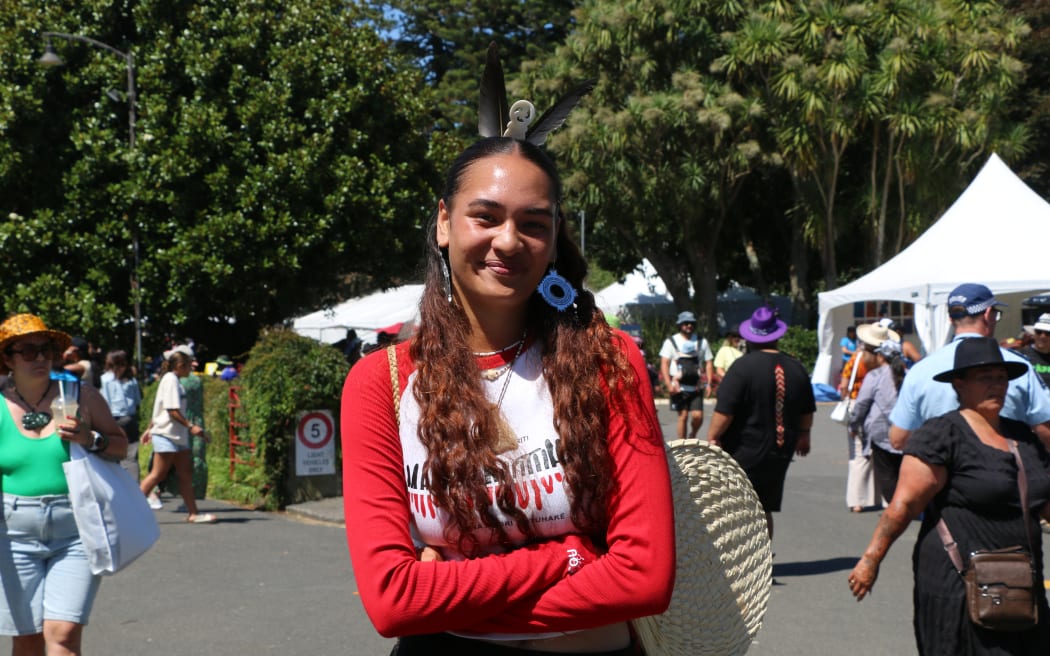 Manaia Tuwhare-Hoani, a proud Te Matatini supporter from Te Tai Tokerau is repping mana motuhake, accessorising with taonga, feathers and woven fan and pēke.