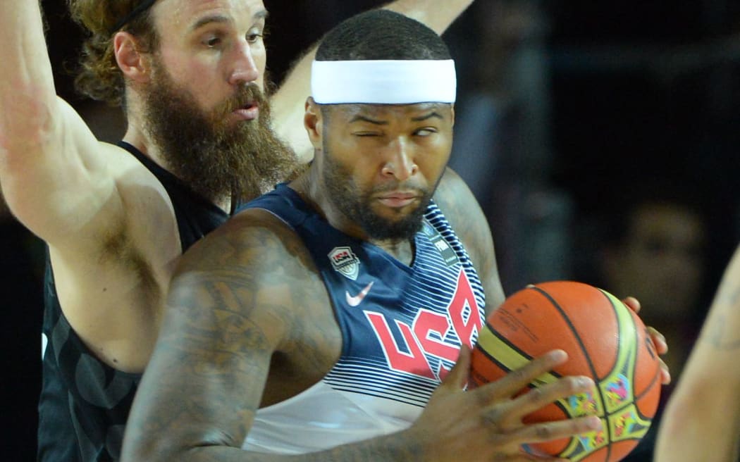 Demarcus Cousins is blocked by New Zealand's Casey Frank, 2014.