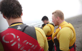 A group of Surf Life Saving lifeguards model lifejackets at Muriwai Beach, Auckland, on 22 October 2015.