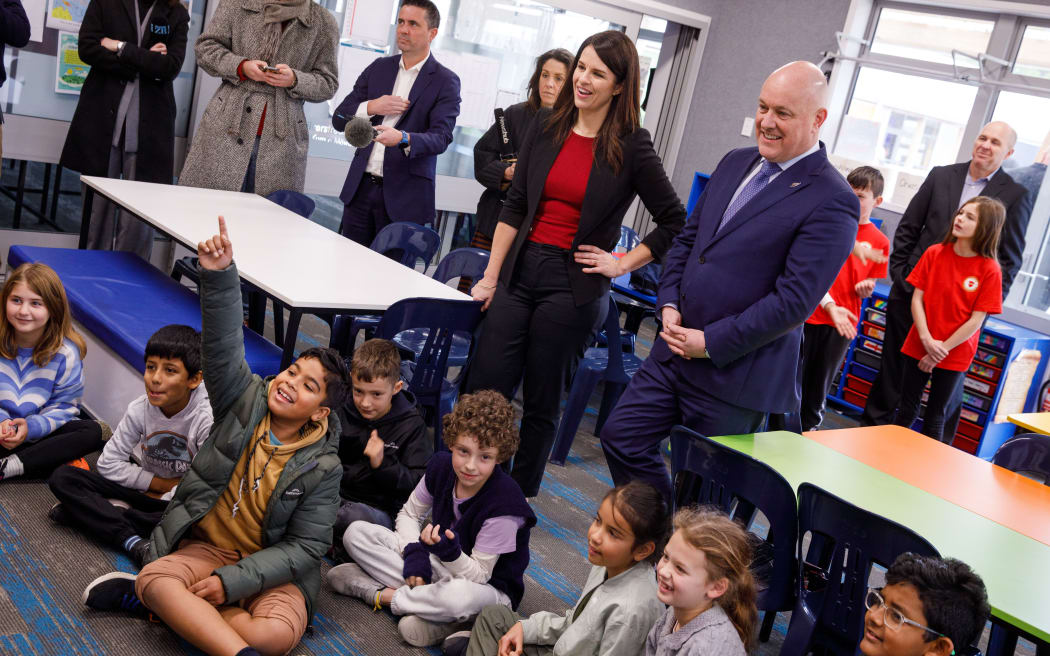 Christopher Luxon and Erica Stanford visiting students at Silverstream Primary School ahead of announcing mandatory reading, writing and maths tests for primary schools.