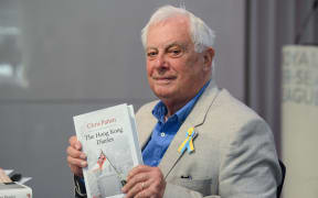 Former Hong Kong governor Lord Chris Patten, poses with his new book "The Hong Kong Diaries" at the end of a press conference to present it, in central London, on June 20, 2022. July 1, 2022 will mark 25 years since Hong Kong was handed to China by Britain. (Photo by Daniel LEAL / AFP)