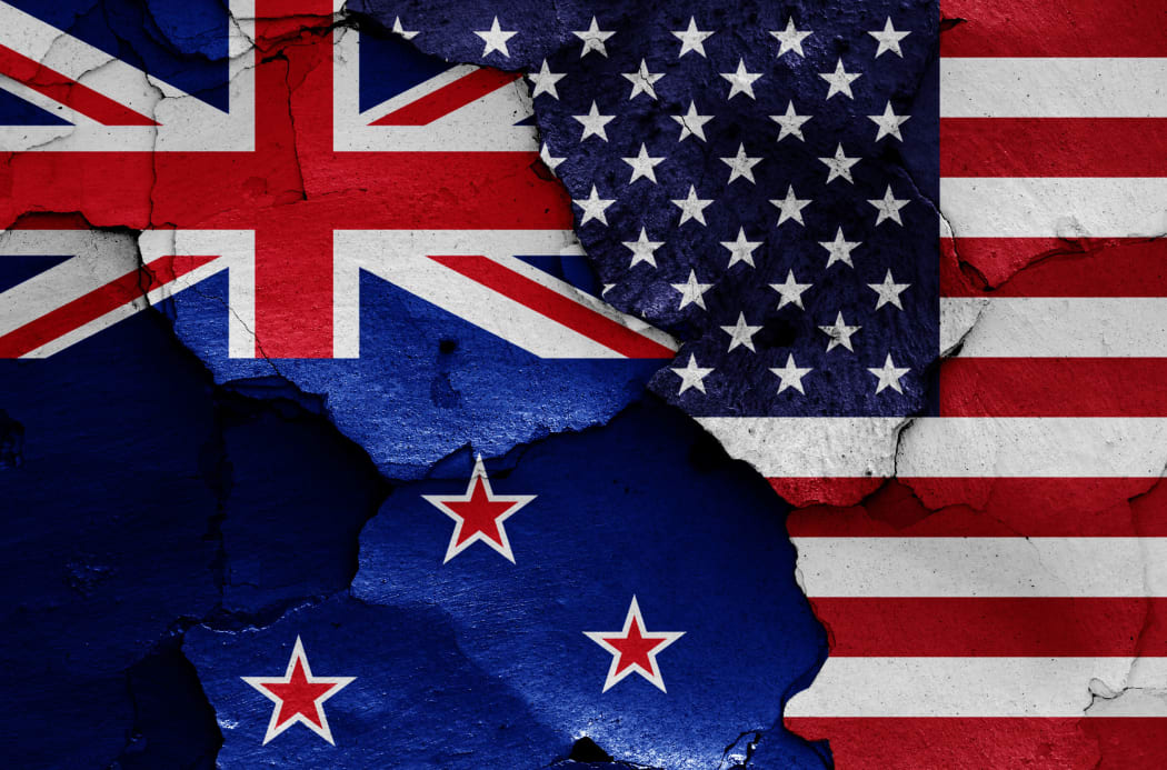 flags of New Zealand and USA painted on cracked wall
