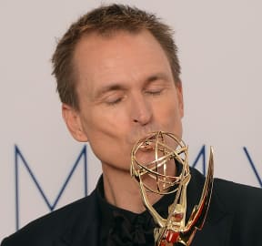 Phil Keoghan celebrates winning an Emmy for the Amazing Race in 2012.