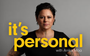 Photo of Anika Moa in black with hands on hips, looking straight ahead to camera, on a light grey background. The podcast title ‘It’s Personal with Anika Moa ’ Is written in in front of her.