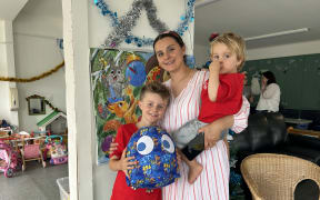 Picture of a mother with her two boys.