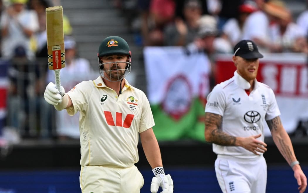 Australia’s Travis Head (L) celebrates reaching his half century (50-runs) on day 2 of the first Ashes cricket Test match between Australia and England at Perth Stadium in Perth on November 22, 2025. (Photo by Saeed KHAN / AFP) / --IMAGE RESTRICTED TO EDITORIAL USE - STRICTLY NO COMMERCIAL USE--