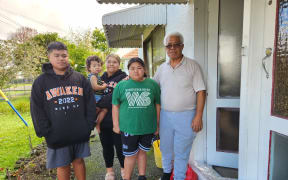 Lesieli Aholelei-Yitiri (second from left), with some of her family outside their home in Wesley next to the Oakley Creek.