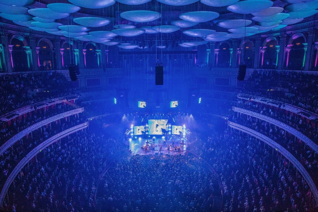 A packed Royal Albert Hall in London where the BBC Symphony Orchestra conducted by Jules Buckley perform a brand new comission for the BBC Proms 2022 written by the band Public Service Broadcasting to celebrate the Centenary of BBC Radio.