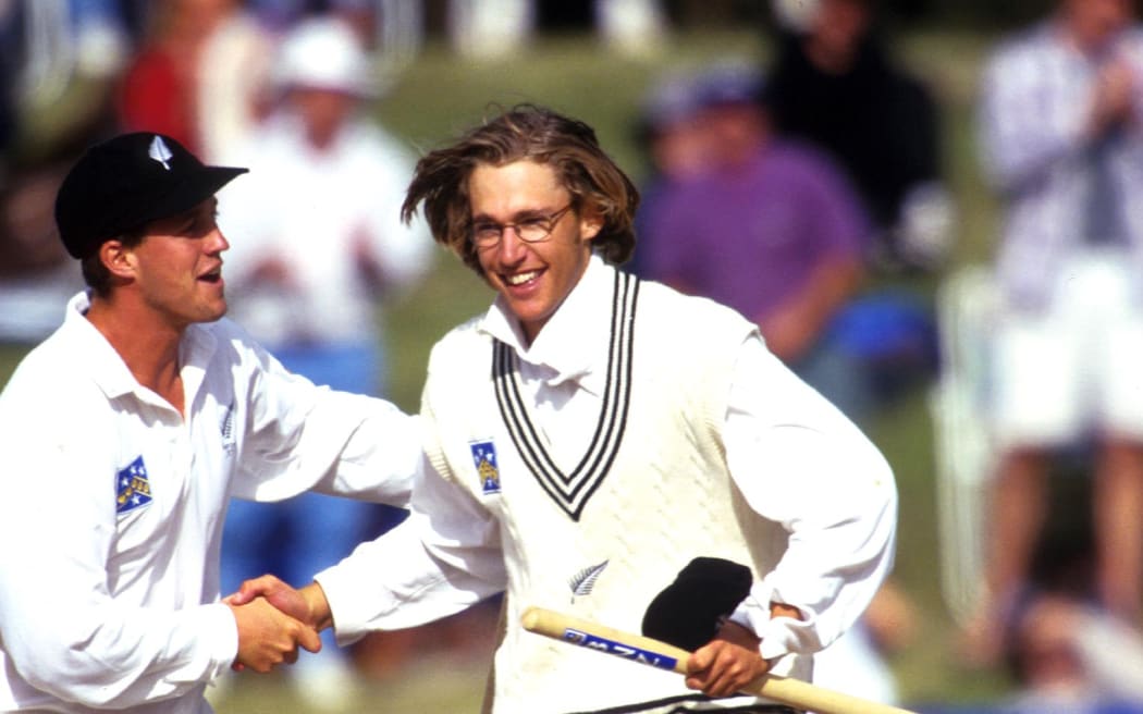 Daniel Vettori celebrates and grabs a souvenir. New Zealand v England. International test match cricket, February 1997.