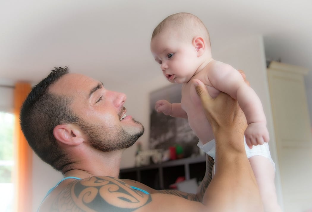 A father singing to his baby