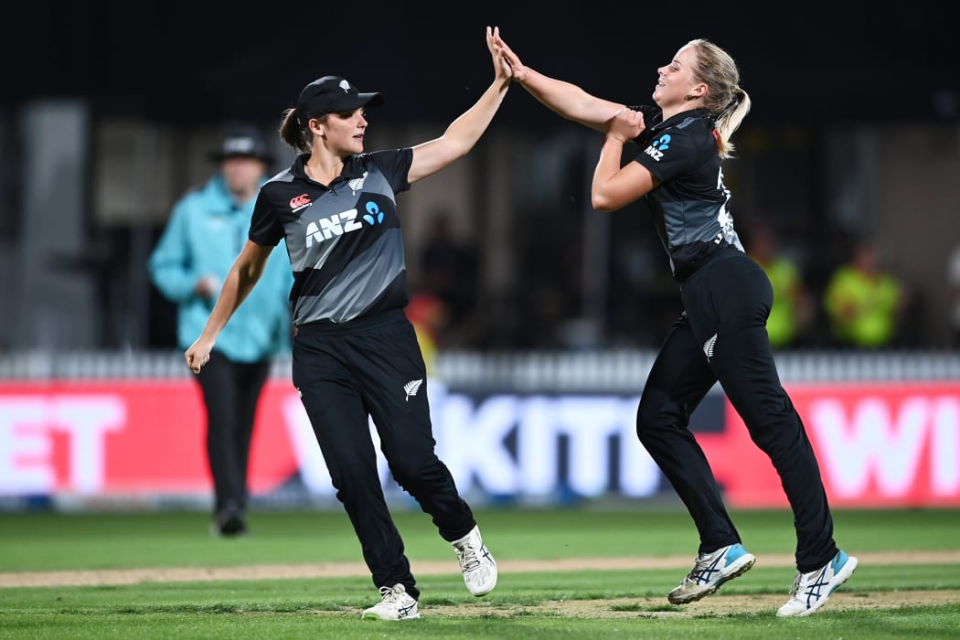Amelia and Jess Kerr celebrate a wicket for the White Ferns.