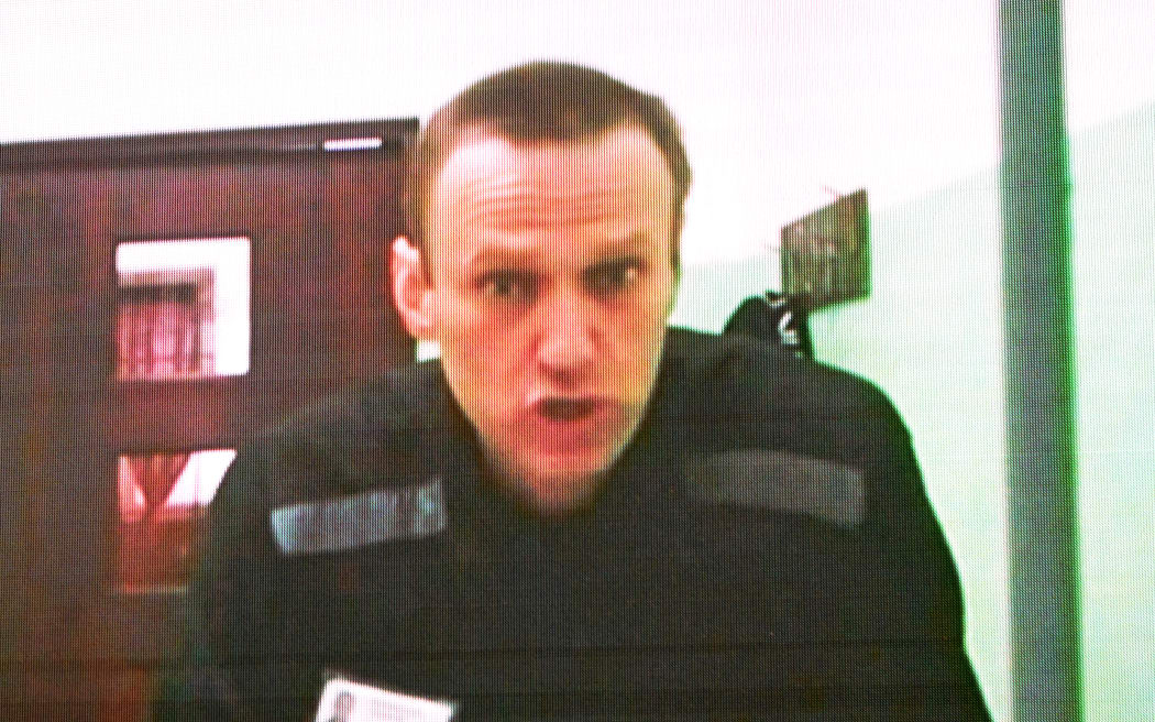 Jailed Russian opposition figure Alexei Navalny is seen on a screen via a video link from his penal colony during court hearings over the extremism criminal case against him at the Russia's Supreme Court in Moscow on June 22, 2023. A Russian court ordered on June 19, 2023, that the trial for Kremlin critic Alexei Navalny be held behind closed doors as he faces extremism charges that could see his time in prison extended for decades. The case comes more than a year into Russia's full-scale offensive in Ukraine, which unleashed an unprecedented crackdown on the Kremlin's critics, with many now in exile or in jail. President Vladimir Putin's most prominent critic is being tried at the maximum security prison where he is jailed: IK-6 penal colony, some 250 kilometres (155 miles) east of Moscow. (Photo by Natalia KOLESNIKOVA / AFP)