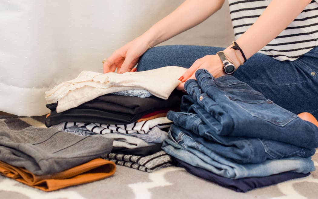 women folding laundry