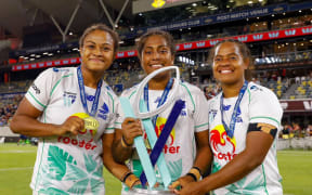 Fijiana captain Bilika Tawake, centre, holds the Super W trophy