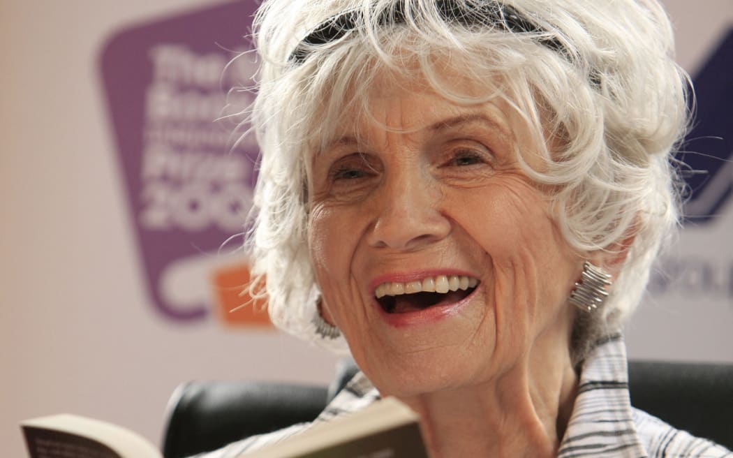 Canadian author Alice Munro holds one of her books as she receives her Man Booker International award at Trinity College Dublin, in Dublin, Ireland, on June 25, 2009. Canadian short story writer Alice Munro has won this year's Man Booker International Prize worth 60,000 pounds (95,000 US dollars, 70,000 euros).  It is awarded every two years, and since its creation in 2005 has been given to Albania's Ismail Kadare and Nigeria's Chinua Achebe. The panel, which comprised writers Jane Smiley, Amit Chaudhuri and Andrey Kurkov, praised the 77-year-old for the originality and depth of her work. AFP PHOTO/ Peter Muhly (Photo by PETER MUHLY / AFP)