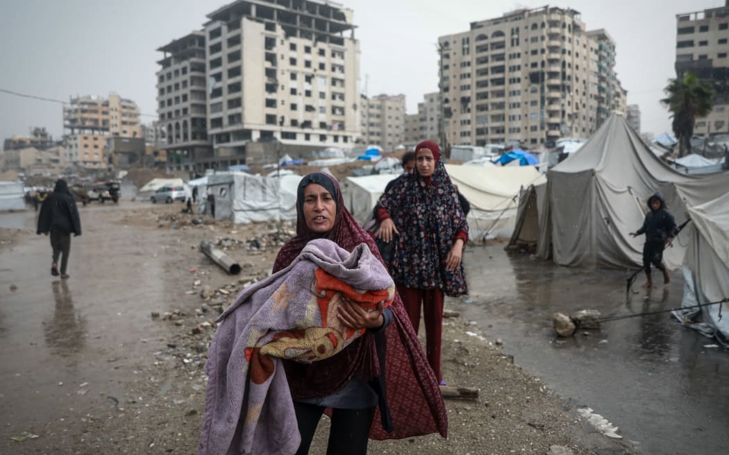 Palestinians, whose homes were destroyed during Israel's two-year attacks, have hard times after their makeshift tents were flooded with the intense rain in Gaza City, Gaza on Friday.