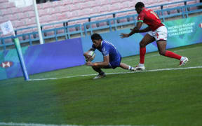 In Krakow, Poland, on April 12, 2025, John Vaili from Samoa (blue) is attacked by Fabio Conceicao from Portugal (red) during the rugby 7s final match as part of the World Rugby HSBC Sevens Challenger final tournament at the Henryk Reyman Municipal Stadium. The World Rugby HSBC Sevens Challenger is a three-round competition where the top four teams have a chance to qualify for the grand final in Los Angeles. Only the top eight teams qualify for the final tournament in Krakow. (Photo by Klaudia Radecka/NurPhoto) (Photo by Klaudia Radecka / NurPhoto / NurPhoto via AFP)