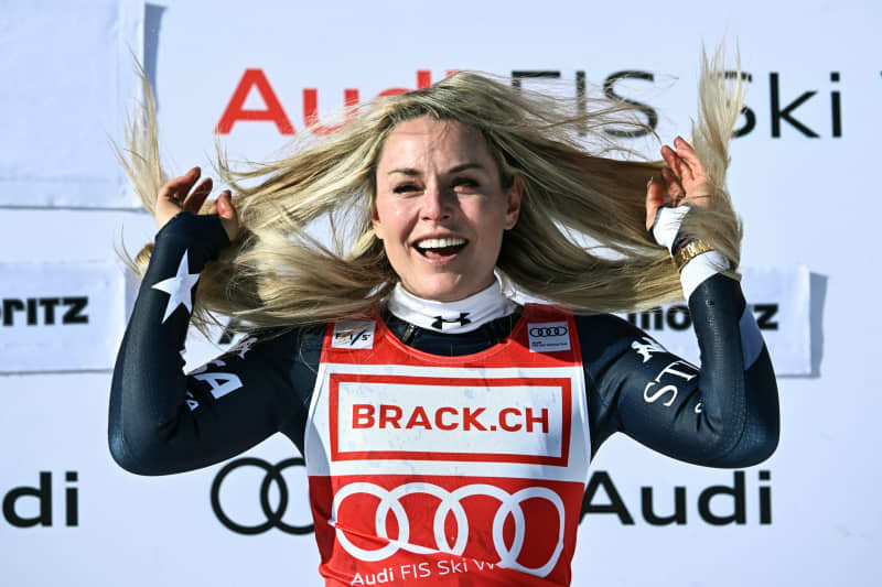First-placed US Lindsey Vonn celebrates after winning the women's downhill at the FIS Alpine Ski World Cup 2025-2026, in St Moritz, Switzerland on December 12, 2025. (Photo by Fabrice COFFRINI / AFP)
