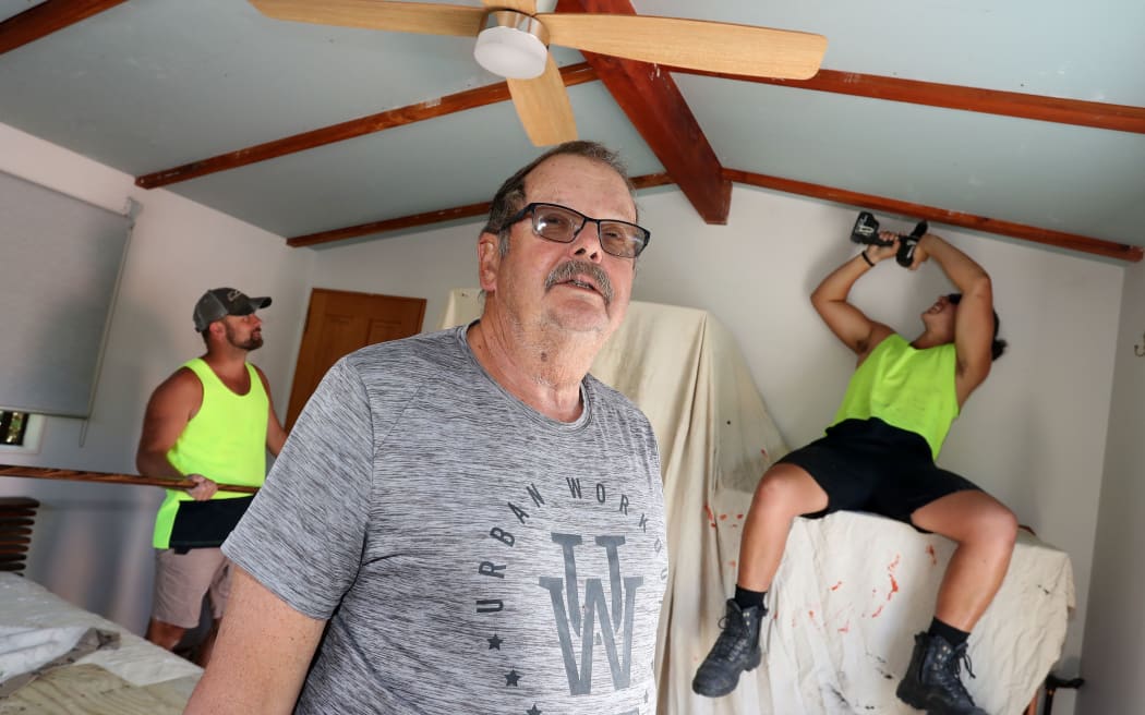 Roger de Bray has had his ceiling sound proofed to cut down the noise of the rescue helicopter, in background are builders Matt Lillywhite and Grayson Pukeroa from JKC Construction.
24 March 2021 Northern Advocate photograph by Michael Cunningham