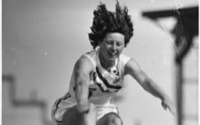Yvette Williams long jumping at Carisbrook park, Dunedin