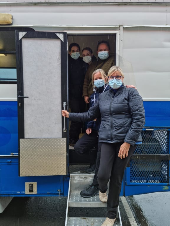 Nelson Marlborough Health staff at the bus used for Covid-19 vaccinations at a pop up event for tradies at Mitre10 Mega in Nelson.