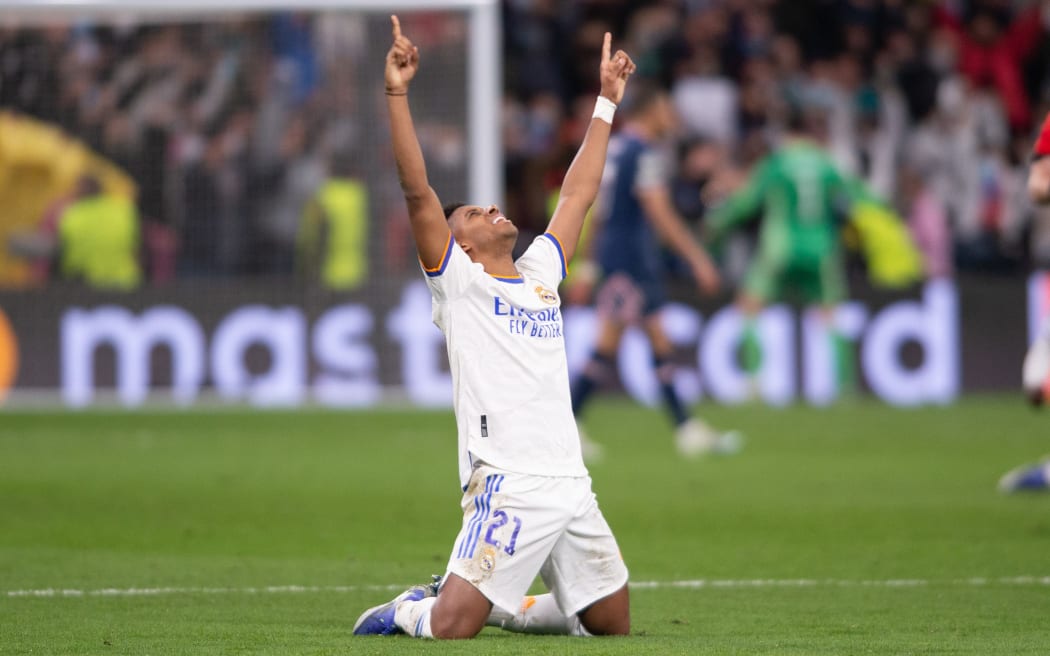 A Rodrygo double has guided defending champions Real Madrid into the final four of the Champions League.