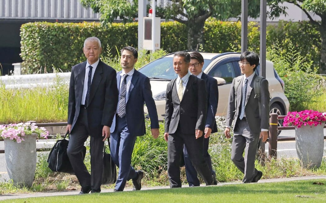Officials from the Ministry of Land, Infrastructure, Transport and Tourism enter Toyota Motor Corp.'s headquarters for an inspection in Toyota City, Aichi prefecture on June 4, 2024. Japanese transport officials inspected Toyota's headquarters June 4 after the top-selling automaker and four others including Honda and Mazda admitted failure to fully comply with national vehicle inspection standards. (Photo by JIJI Press / AFP) / Japan OUT